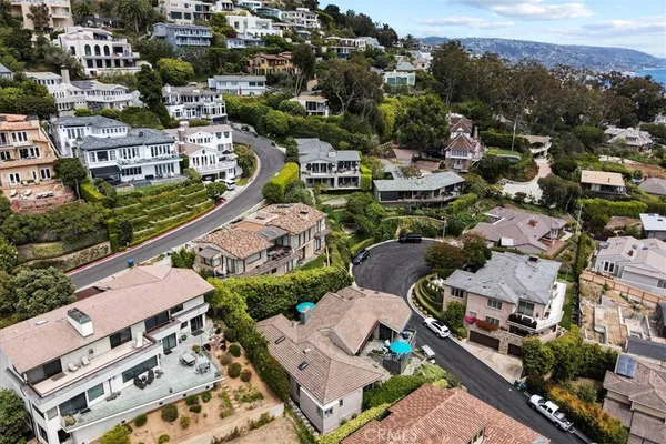 an aerial view of residential houses with city view