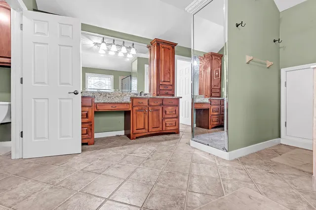 a view of kitchen with stainless steel appliances granite countertop a refrigerator and a sink