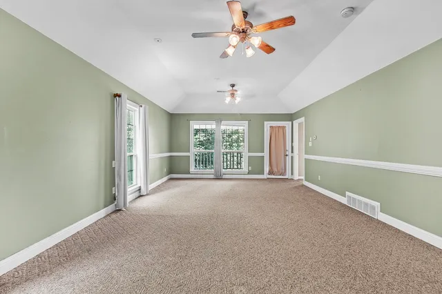 a view of a livingroom with a ceiling fan and window