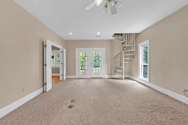 a view of a livingroom with a ceiling fan and window