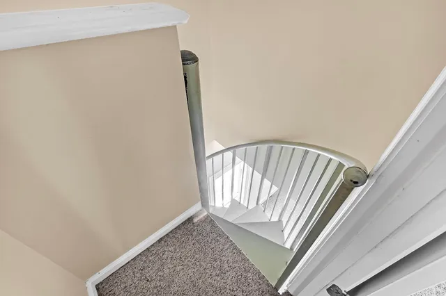 a view of staircase with white walls