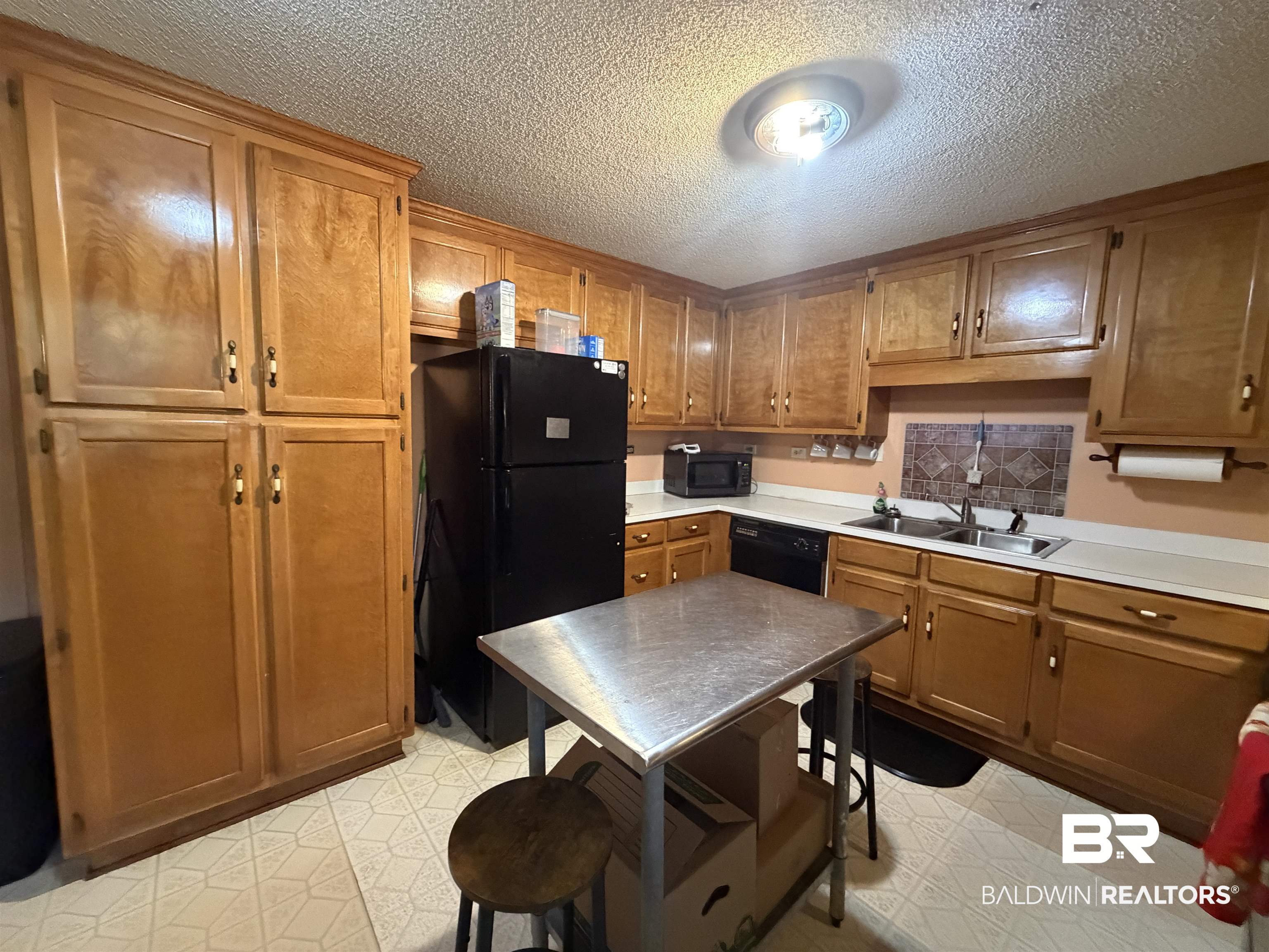 1401 East Forest Ridge Road Mobile, AL 36618 - Photo 5 of 19 Kitchen featuring extensive wood-finish cabinetry, white countertops, a double basin sink, and a tiled backsplash