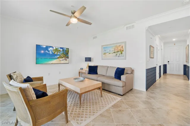 a living room with furniture a rug and a chandelier