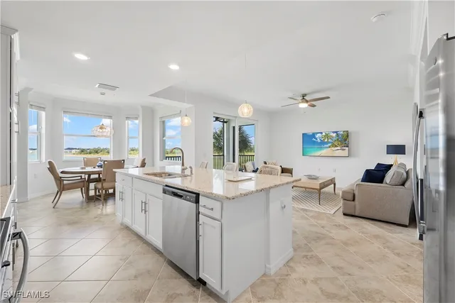 a kitchen with stainless steel appliances kitchen island granite countertop a sink and cabinets