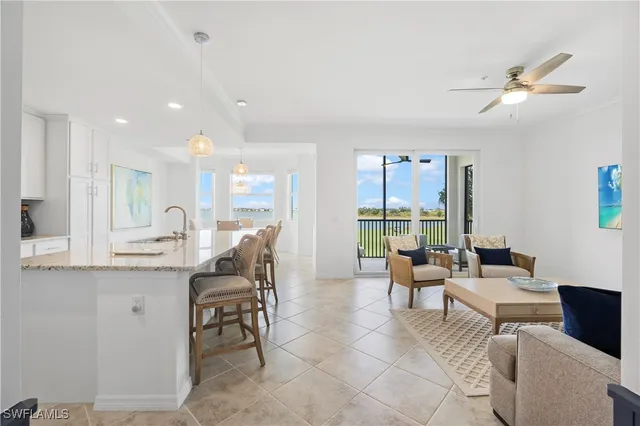 a living room with furniture a window and a chandelier