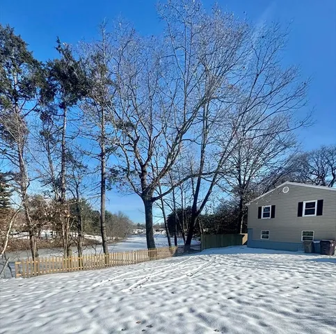 a view of a house with a snow in the yard