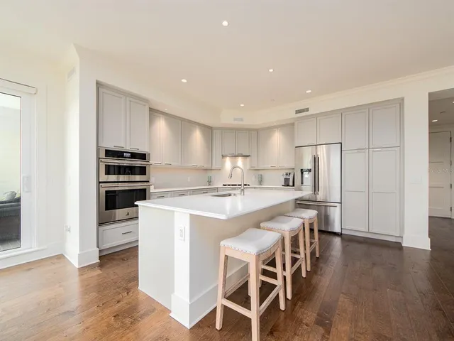 a kitchen with stainless steel appliances a stove a sink and a refrigerator