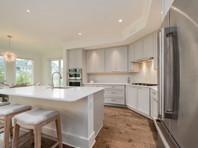 a kitchen with refrigerator cabinets and a table
