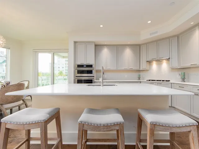 a kitchen with a table chairs sink and cabinets