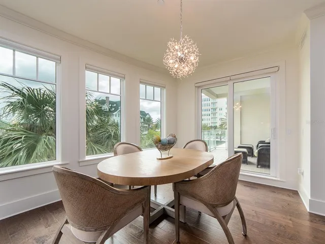 a dining room with furniture a window and a chandelier