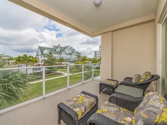 a view of a city from a balcony with furniture