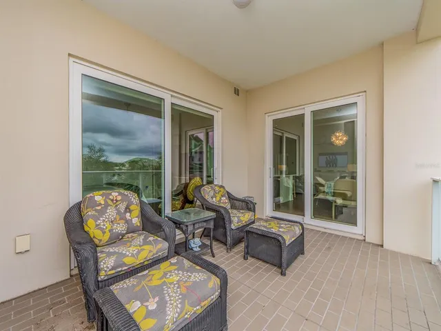 a living room with furniture and a window with garden view