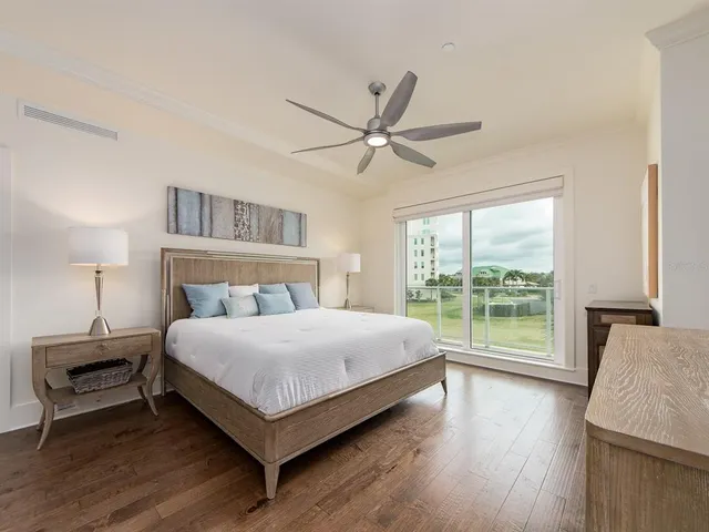 a bedroom with a large bed and a large window