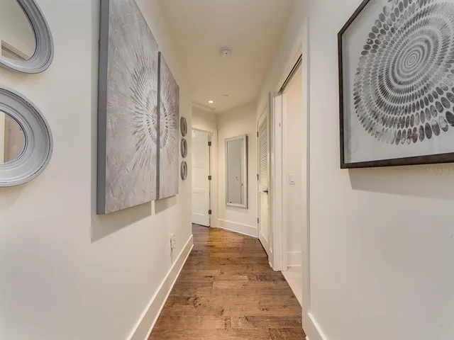 a view of a hallway with wooden floor