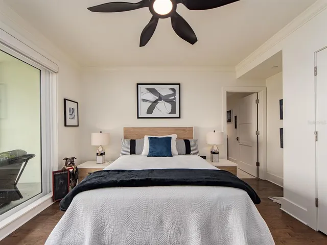 a bedroom with a large bed and a chandelier