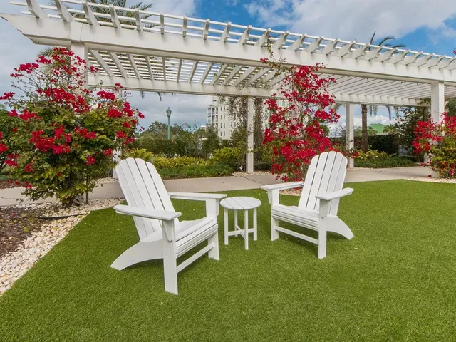 a view of a chairs and tables in the patio and a fountain in the patio