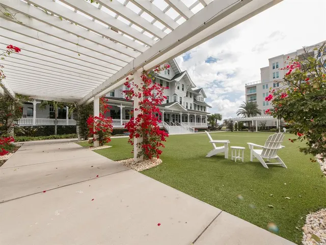 a view of a patio with table and chairs and potted plants