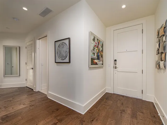 an empty room with wooden floor and window