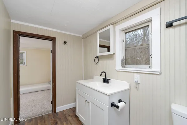a bathroom with a sink mirror and window