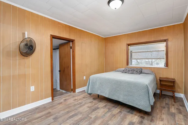 a bedroom with a bed and a window