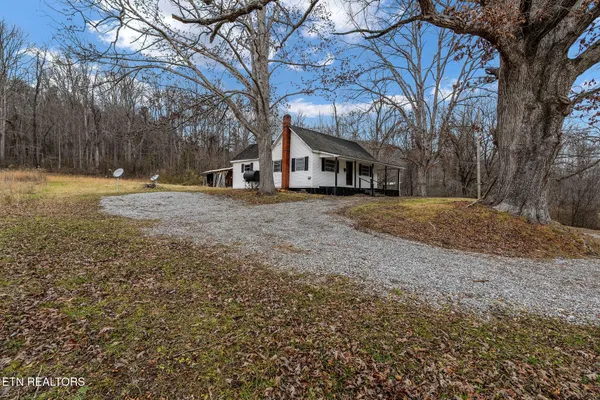 a view of a yard with wooden fence