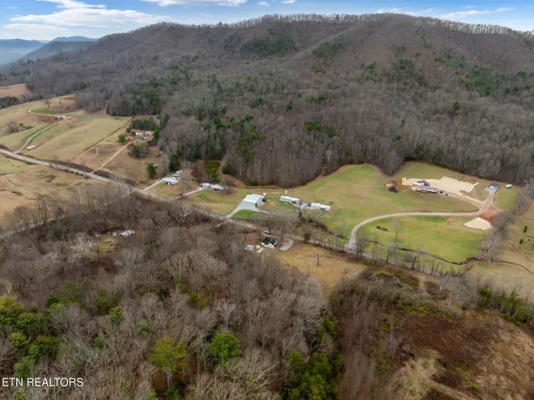 a backyard of a house with a yard and outdoor seating