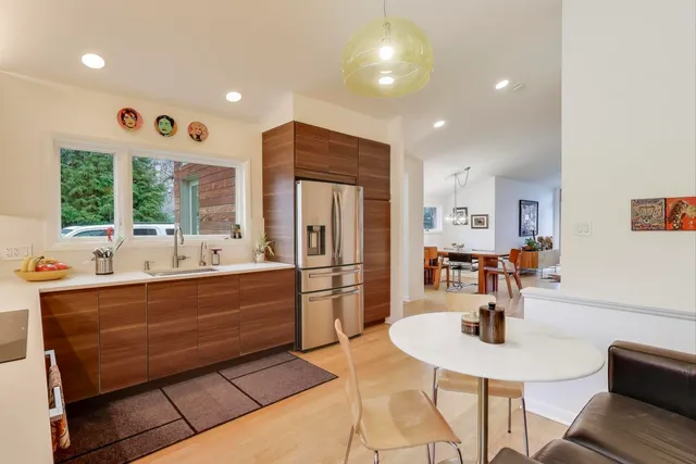 a kitchen with stainless steel appliances kitchen island granite countertop a sink and cabinets