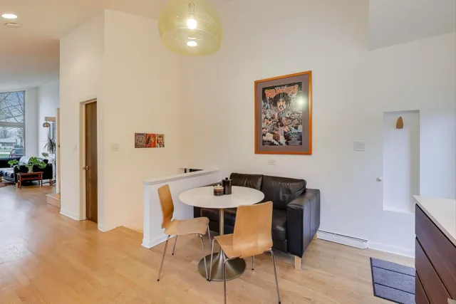 a dining room with furniture and wooden floor
