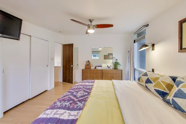 a bed room with a bed and a television