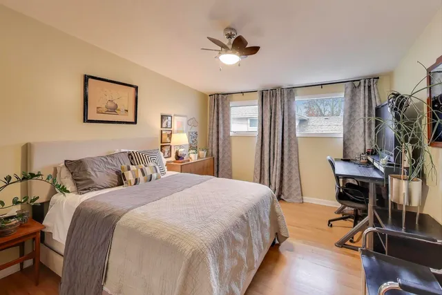 a bed room with a bed and a chair