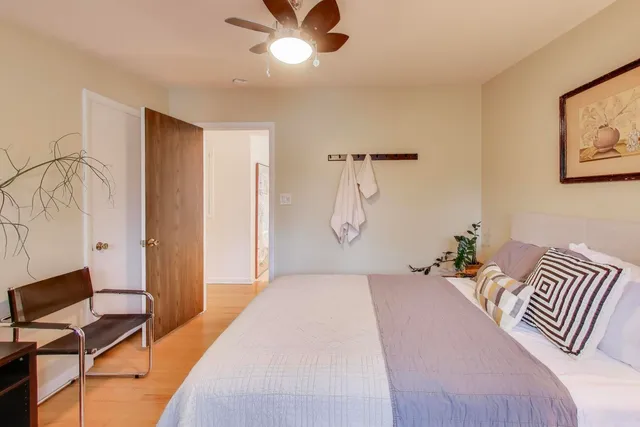 a bedroom with a bed and a chandelier