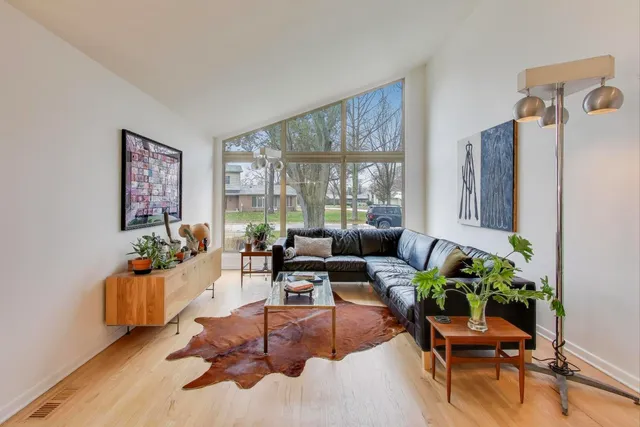 a living room with furniture and a potted plant