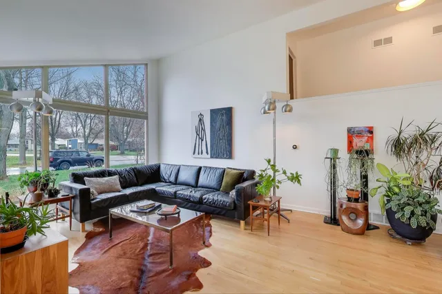 a living room with furniture and a potted plant