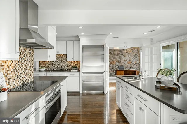 a kitchen with stainless steel appliances a sink dishwasher stove refrigerator and microwave