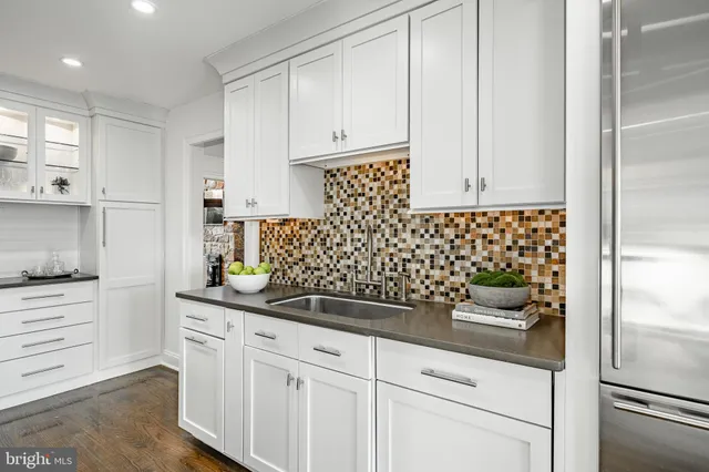 a kitchen with stainless steel appliances granite countertop a stove and a sink