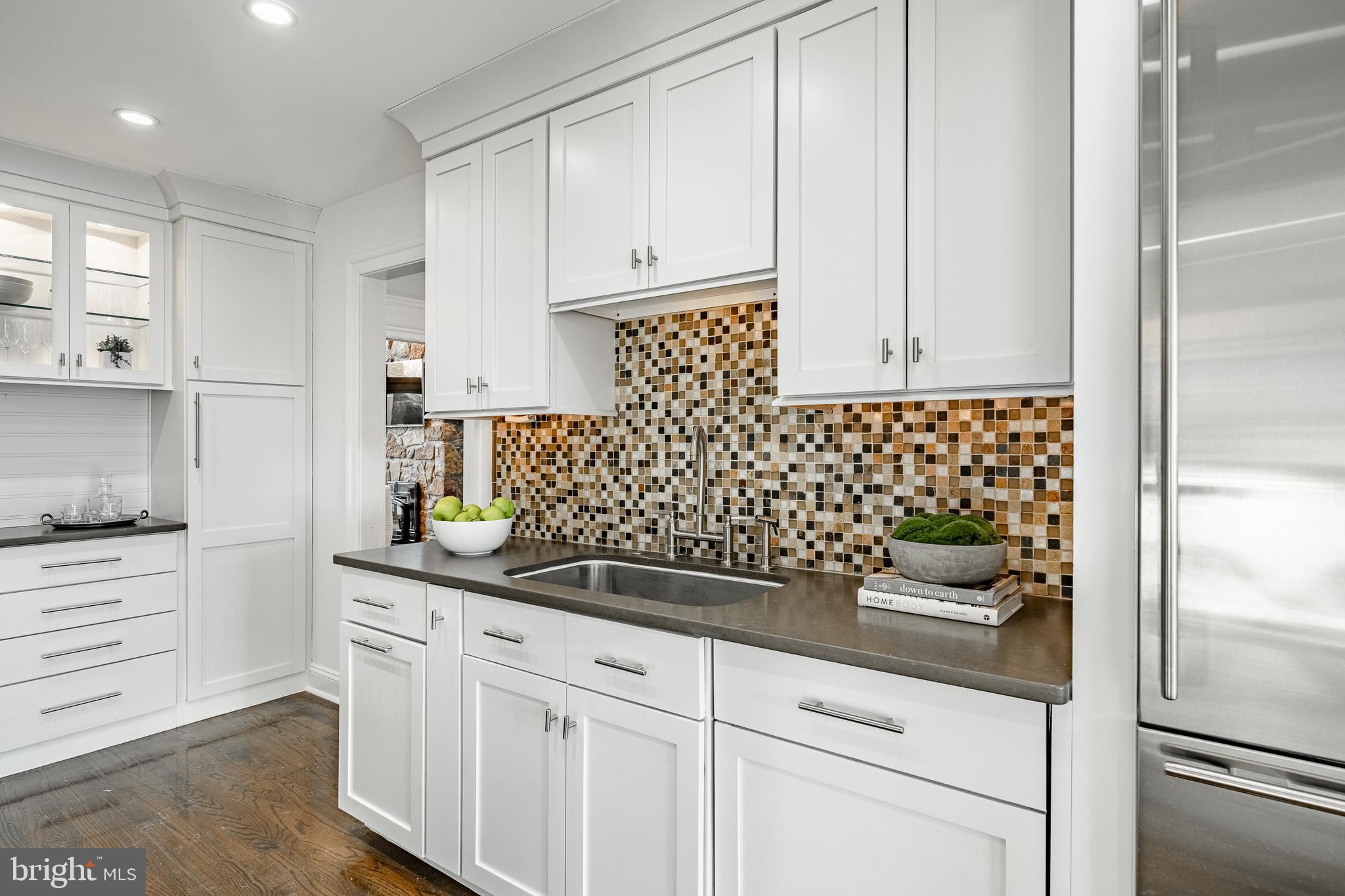 1256 Round Hill Road Bryn Mawr, PA 19010 - Photo 16 of 65 a kitchen with granite countertop white cabinets and stainless steel appliances