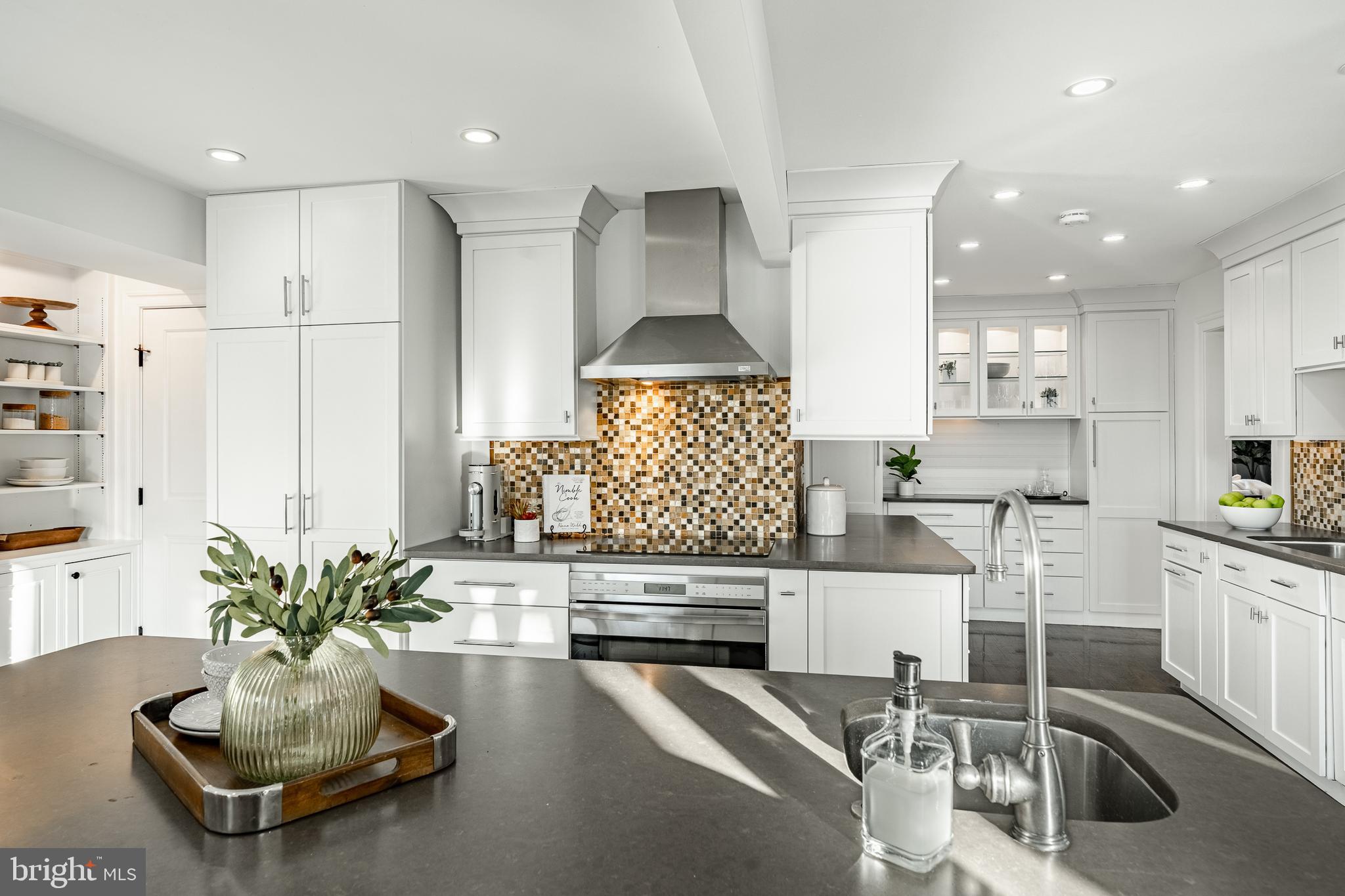 1256 Round Hill Road Bryn Mawr, PA 19010 - Photo 23 of 65 a kitchen with stainless steel appliances kitchen island granite countertop a stove and white cabinets