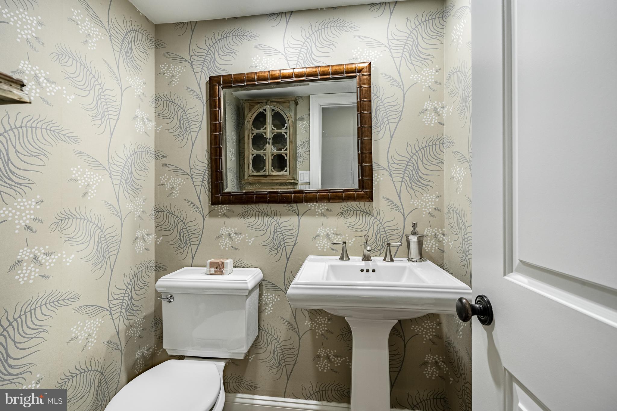 1256 Round Hill Road Bryn Mawr, PA 19010 - Photo 27 of 65 a bathroom with a sink and mirror with toilet