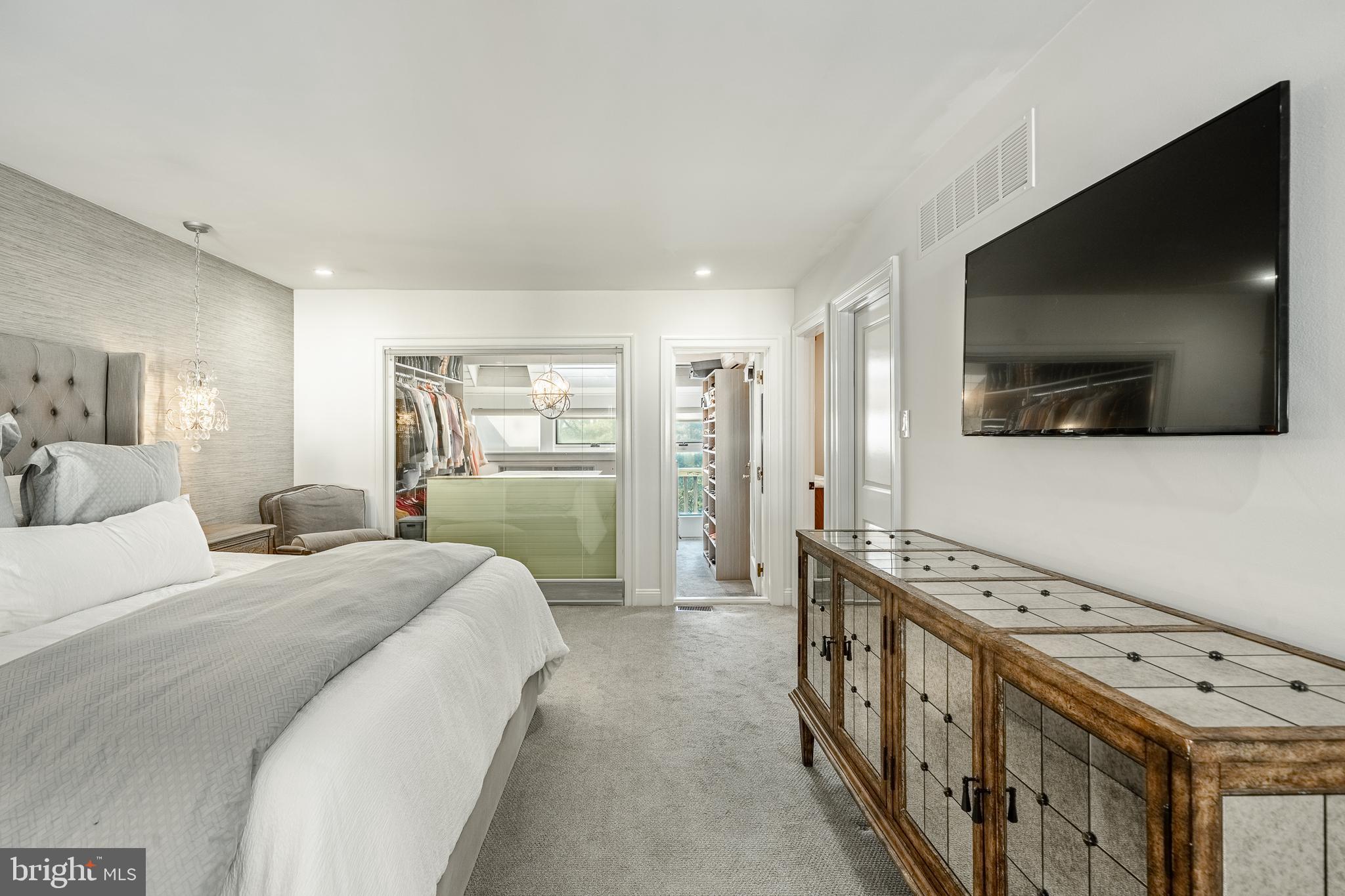 1256 Round Hill Road Bryn Mawr, PA 19010 - Photo 29 of 65 a spacious bedroom with a bed and a flat screen tv