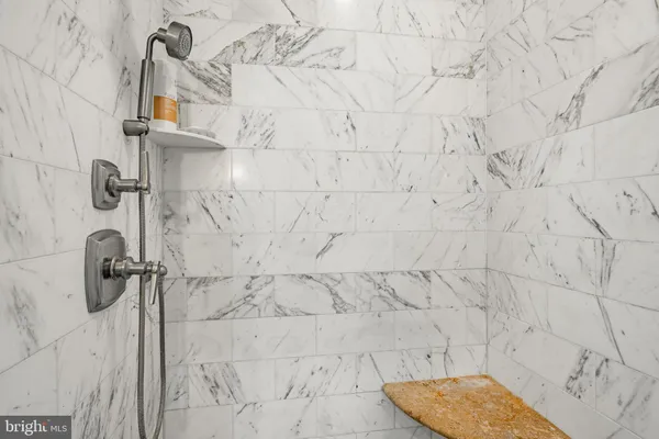 a bathroom with a tub sink shower and mirror