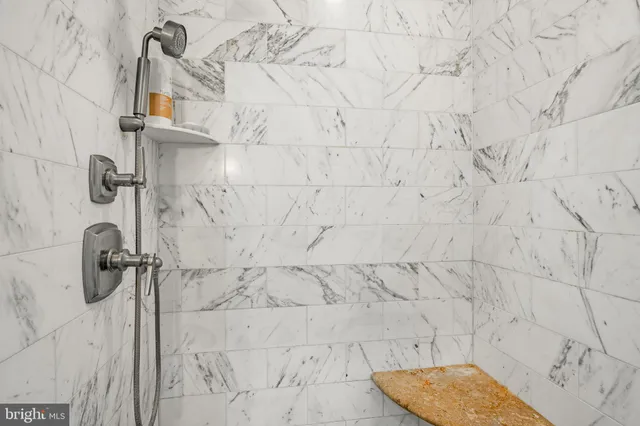 a bathroom with a tub sink shower and mirror