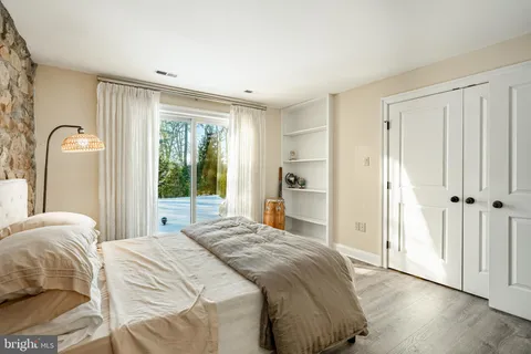 a patio with table and chairs and potted plants