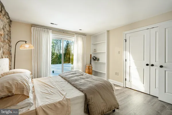 a patio with table and chairs and potted plants