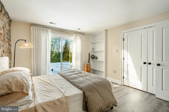 a patio with table and chairs and potted plants