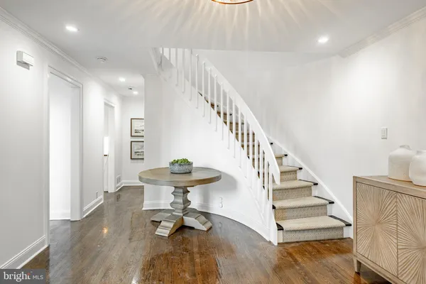 a view of entryway and hall with wooden floor