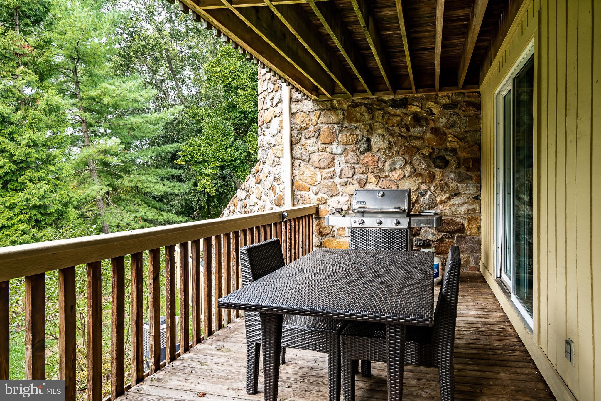 1256 Round Hill Road Bryn Mawr, PA 19010 - Photo 55 of 65 a view of a balcony dining table and chairs