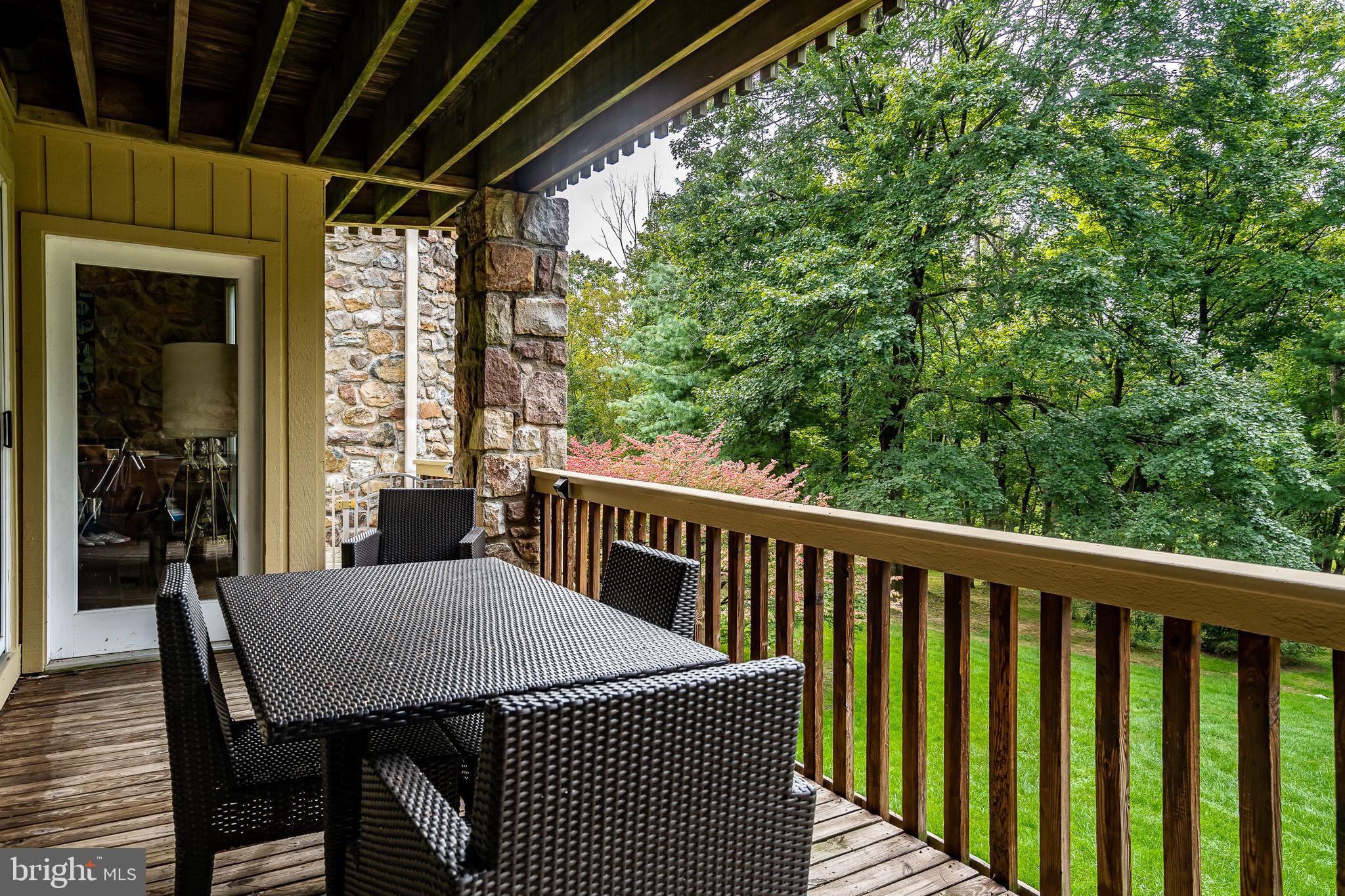 1256 Round Hill Road Bryn Mawr, PA 19010 - Photo 56 of 65 a view of a balcony with table and chairs
