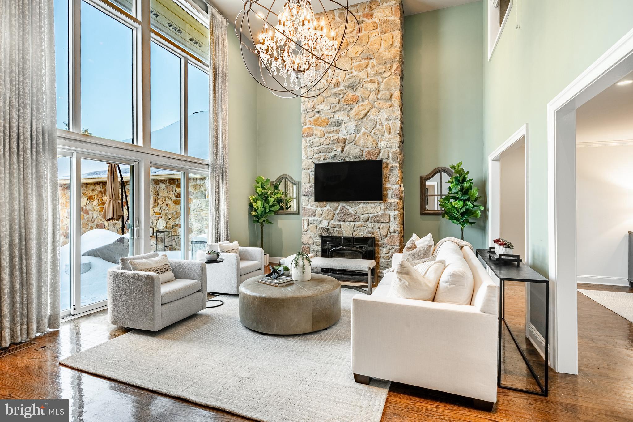 1256 Round Hill Road Bryn Mawr, PA 19010 - Photo 10 of 65 a living room with furniture a fireplace and a flat screen tv