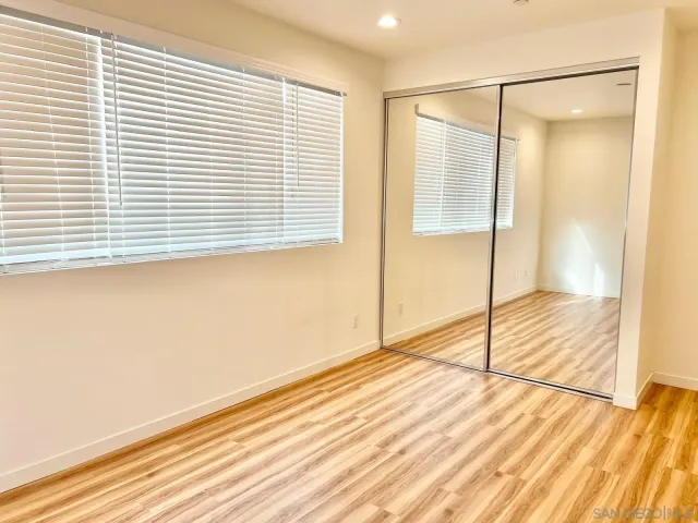 a view of a room with wooden floor and windows