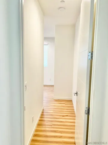 a view of a hallway with wooden floor